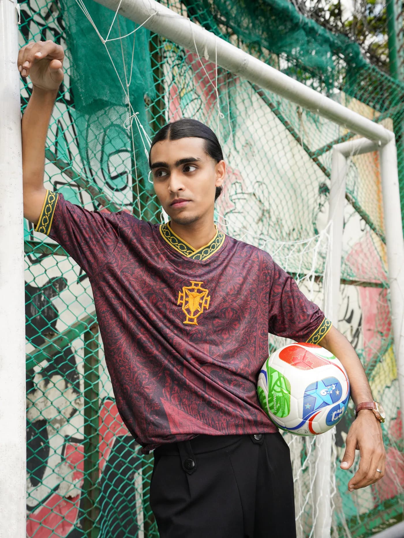 Model in the Saudade jersey leaning on a goalpost